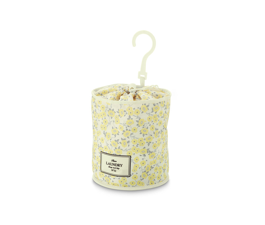Ein weißer Klammerbeutel mit gelben Blumen und einem weißen Plastikhaken.
