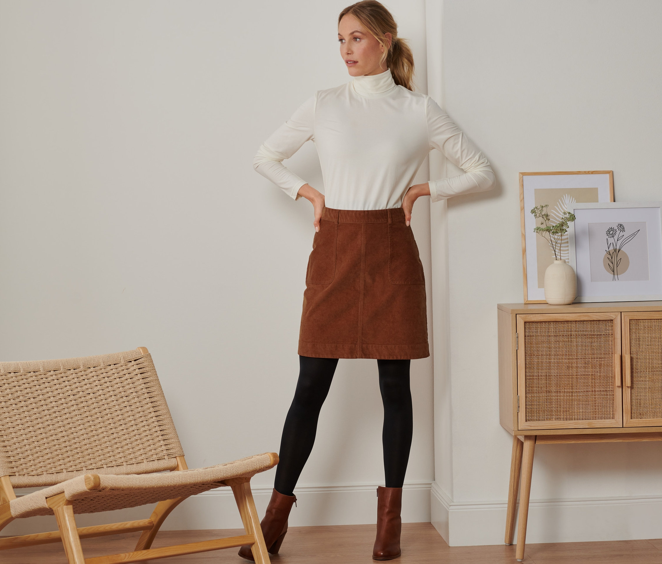 Frau posiert in braunem Cordrock.
