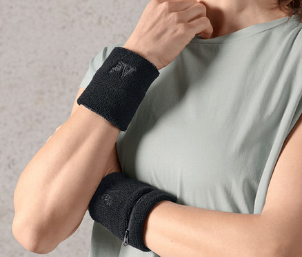 Frau trägt zwei Schweißbänder an beiden Handgelenken.