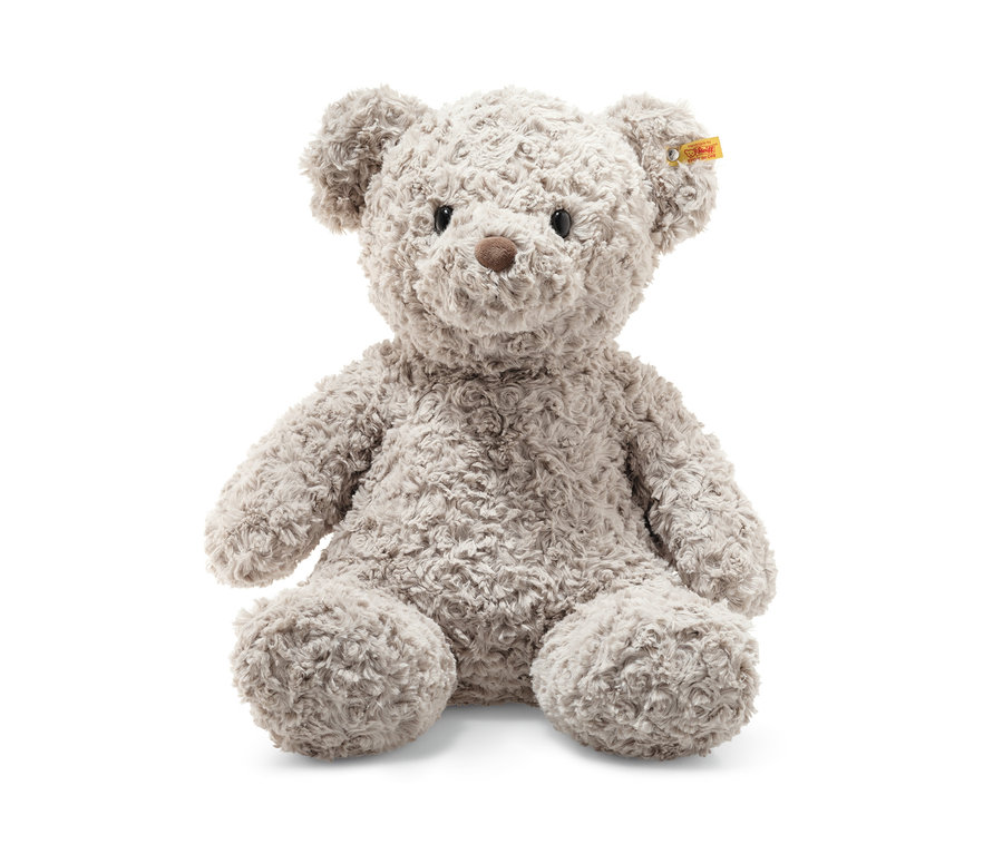 Ein grauer Teddybär sitzt auf einem weißen Hintergrund. Steiff Honey Teddybär, 48 cm