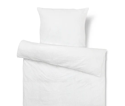 Weißer Kissen- und Bettbezug mit Textur.