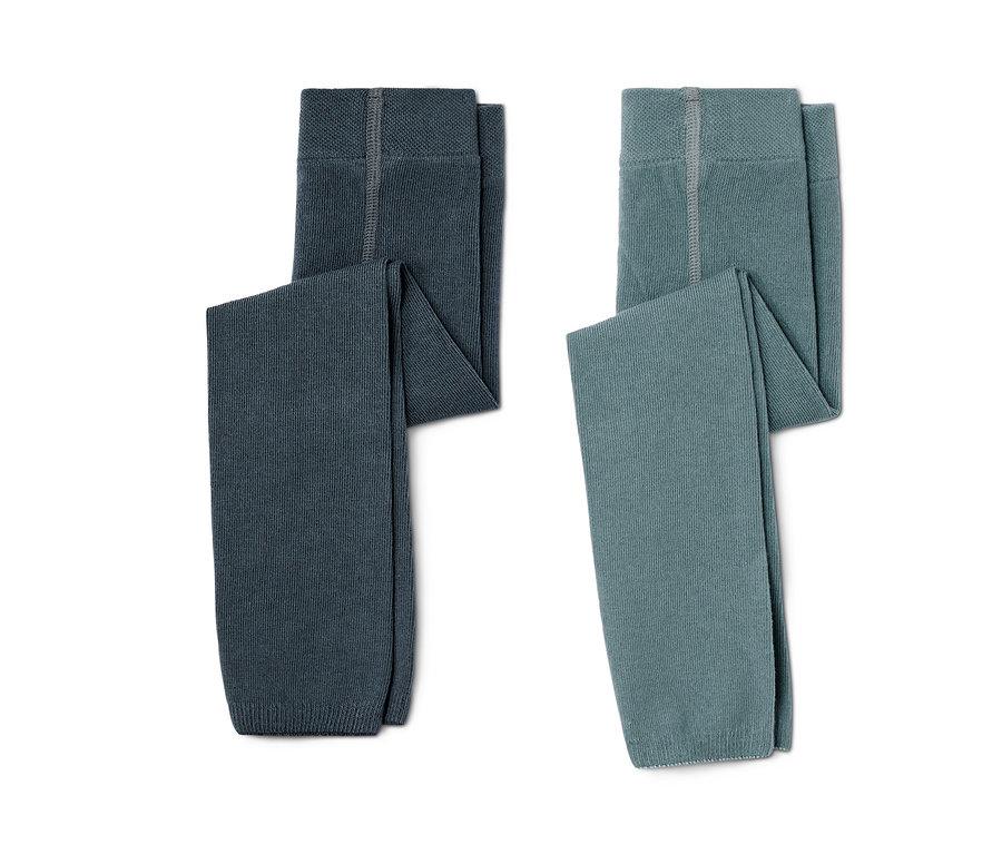 Zwei Kleinkinder-Strickleggings, eine dunkelgrau und die andere blaugrün, liegen nebeneinander auf einem weißen Hintergrund.