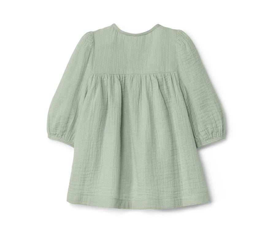 Eine hellgrüne Kinder-Premium-Bluse mit langen Ärmeln auf weißem Hintergrund.
