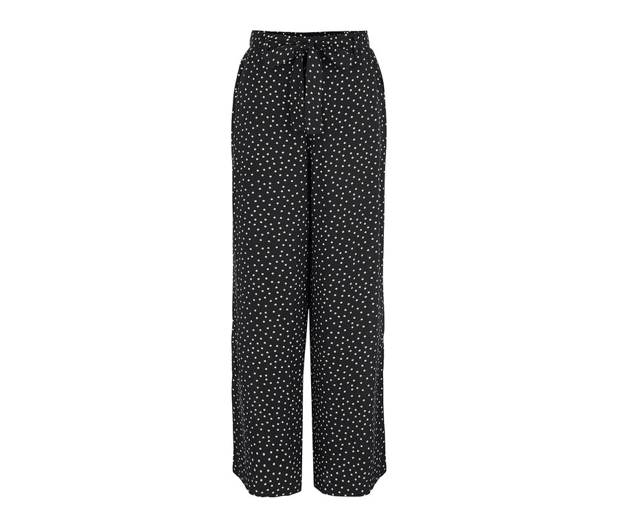 Schwarze Webhose mit weißen Punkten.