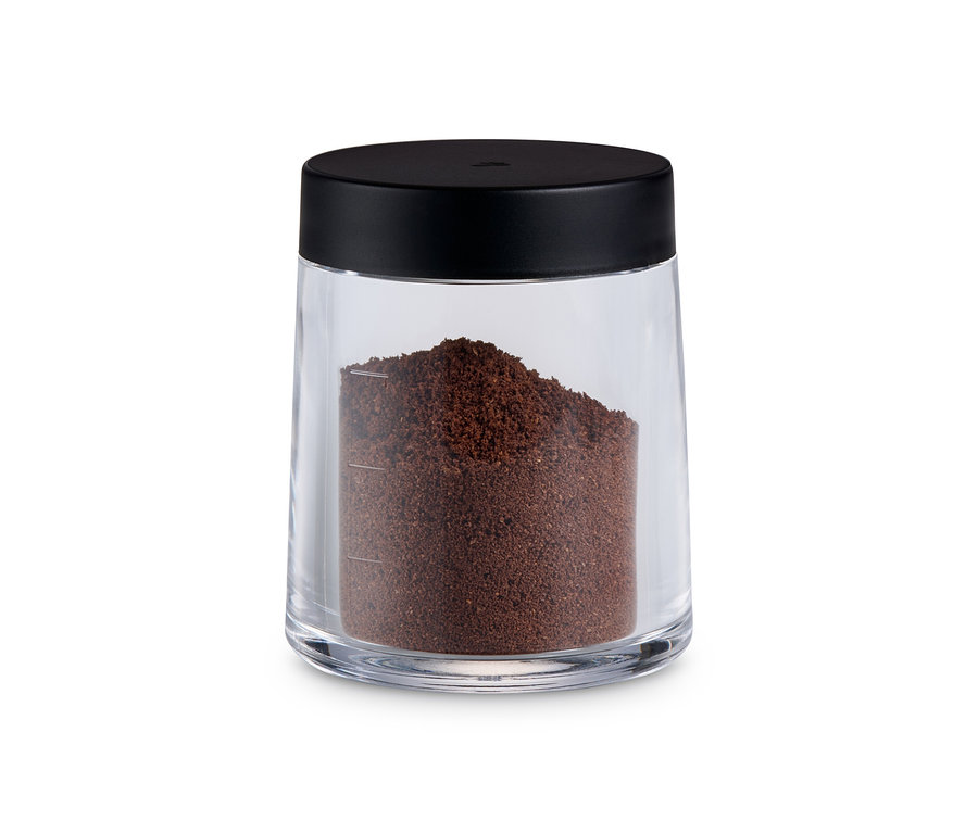 Gemahlener Kaffee in einer manuellen Kaffeemühle, silber.