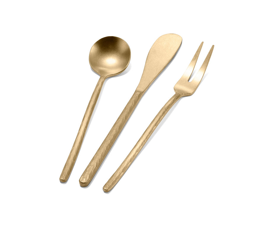 Goldfarbenes 3er-Besteckset liegt auf weißem Hintergrund.