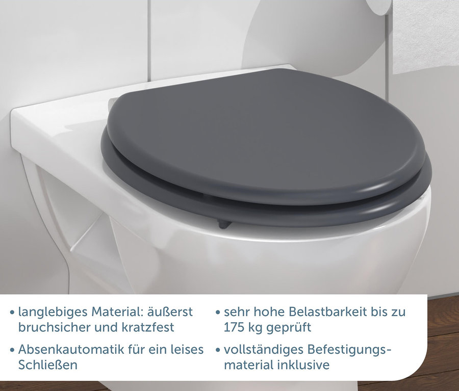 Nahaufnahme eines grauen MDF WC-Sitzes Spirit auf einer weißen Toilette.