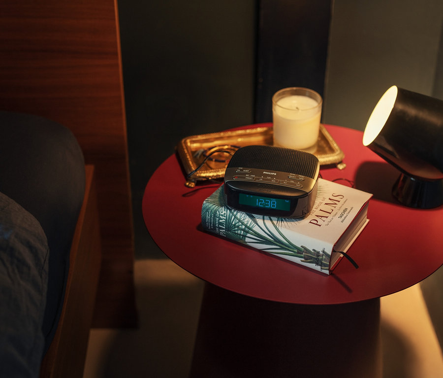 Nachttisch mit Philips Radiowecker »TAR3505«, Buch, Kerze und Lampe.