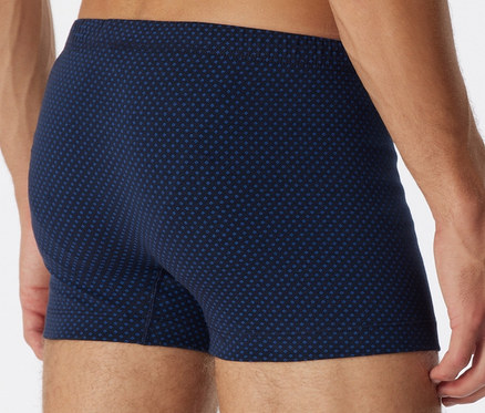 Rückansicht eines Mannes, der SCHIESSER Shorts mit Alloverprint trägt.