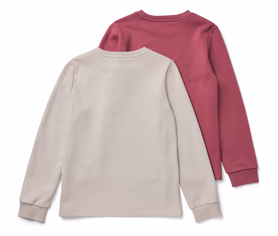 Zwei Kinder-Sweatshirts mit angerauter Innenseite, rosa und weiß.