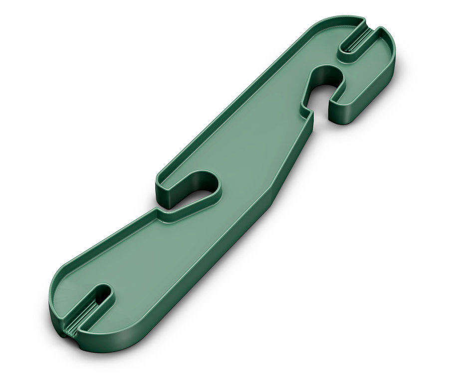 Ein grüner Kabelhalter aus Plastik mit Aussparungen.