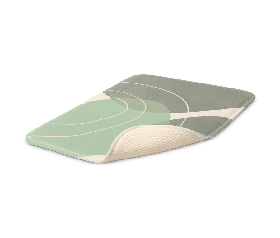 Eine grüne Komfort-Badematte mit abstraktem Design.