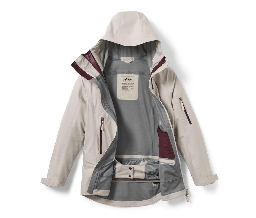 Offene, hellbeige Hardshell-Skijacke mit Kapuze.