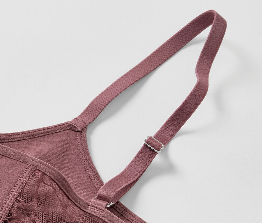 Detailansicht eines braunen Seamless-Bustiers mit Spitze und verstellbarem Träger.