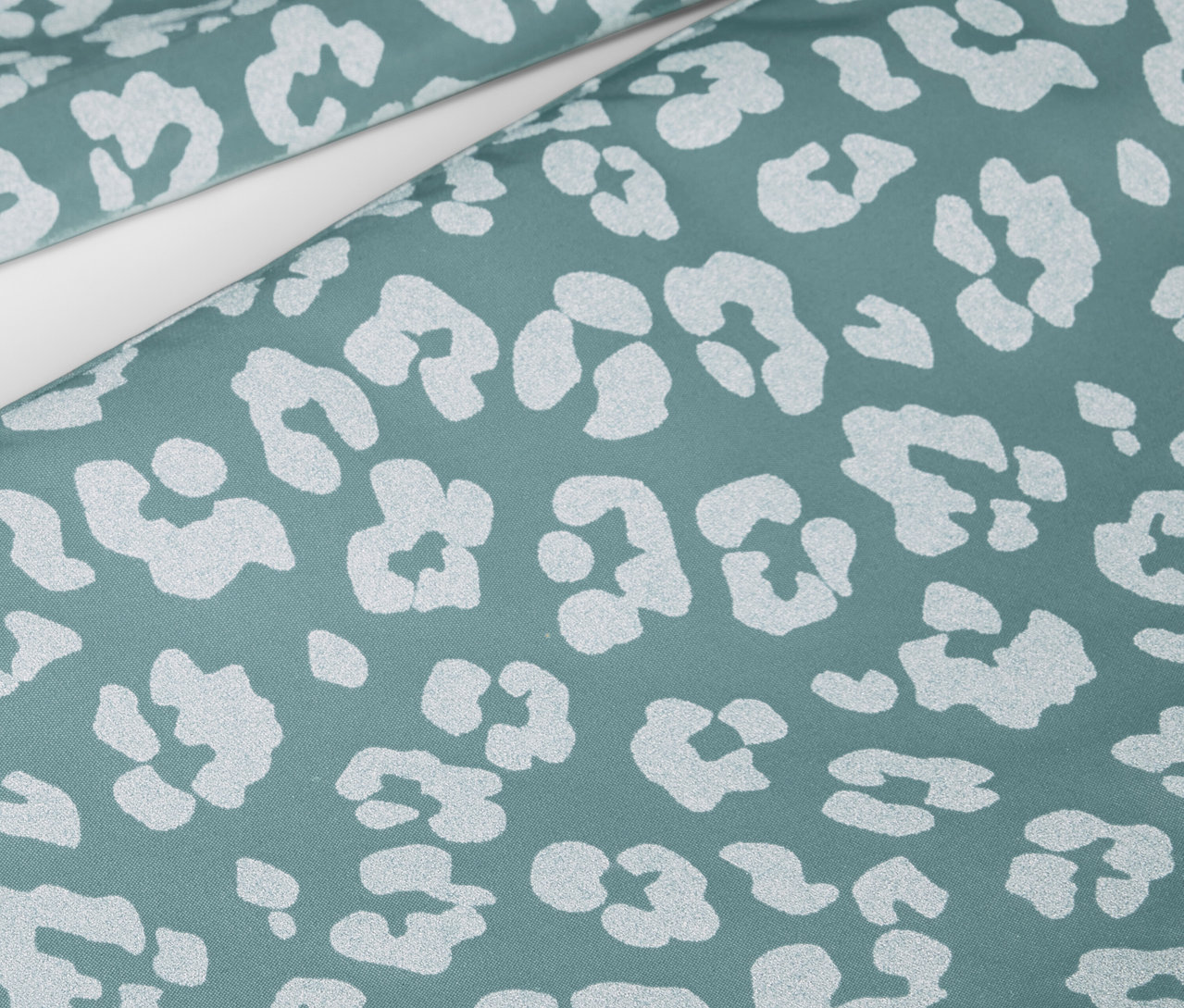 Detailaufnahme einer Kinder-Regenhose mit reflektierenden Elementen und Tiermuster.