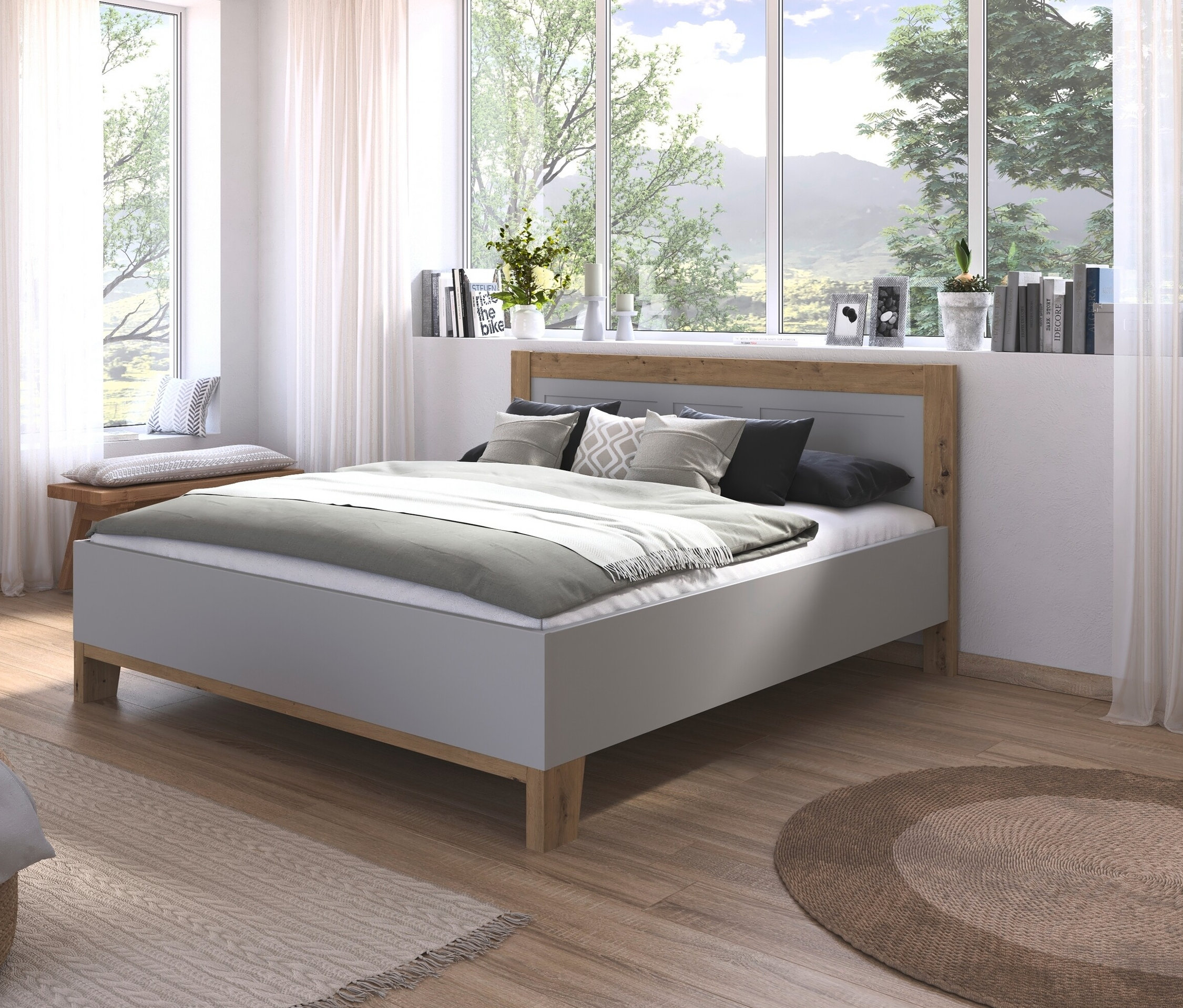Schlafzimmer mit grauem »Credo« Bett, 180 cm, und hellen Holzmöbeln.