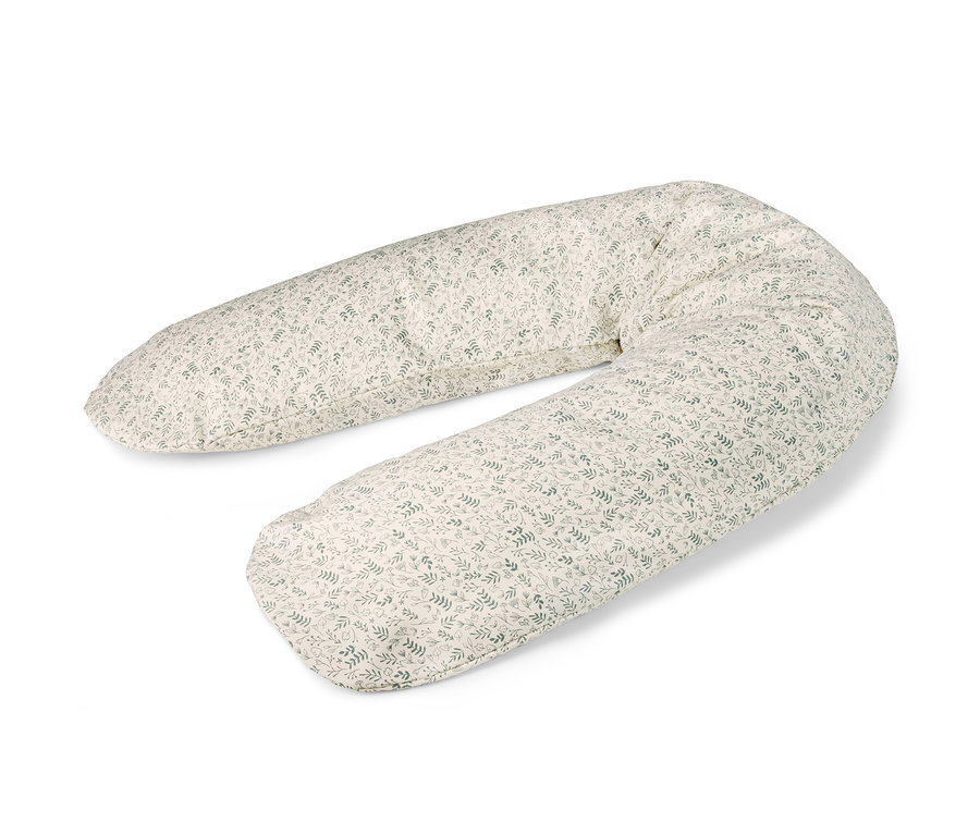 Ein Theraline Stillkissen mit Blattmuster liegt auf einem weißen Hintergrund.