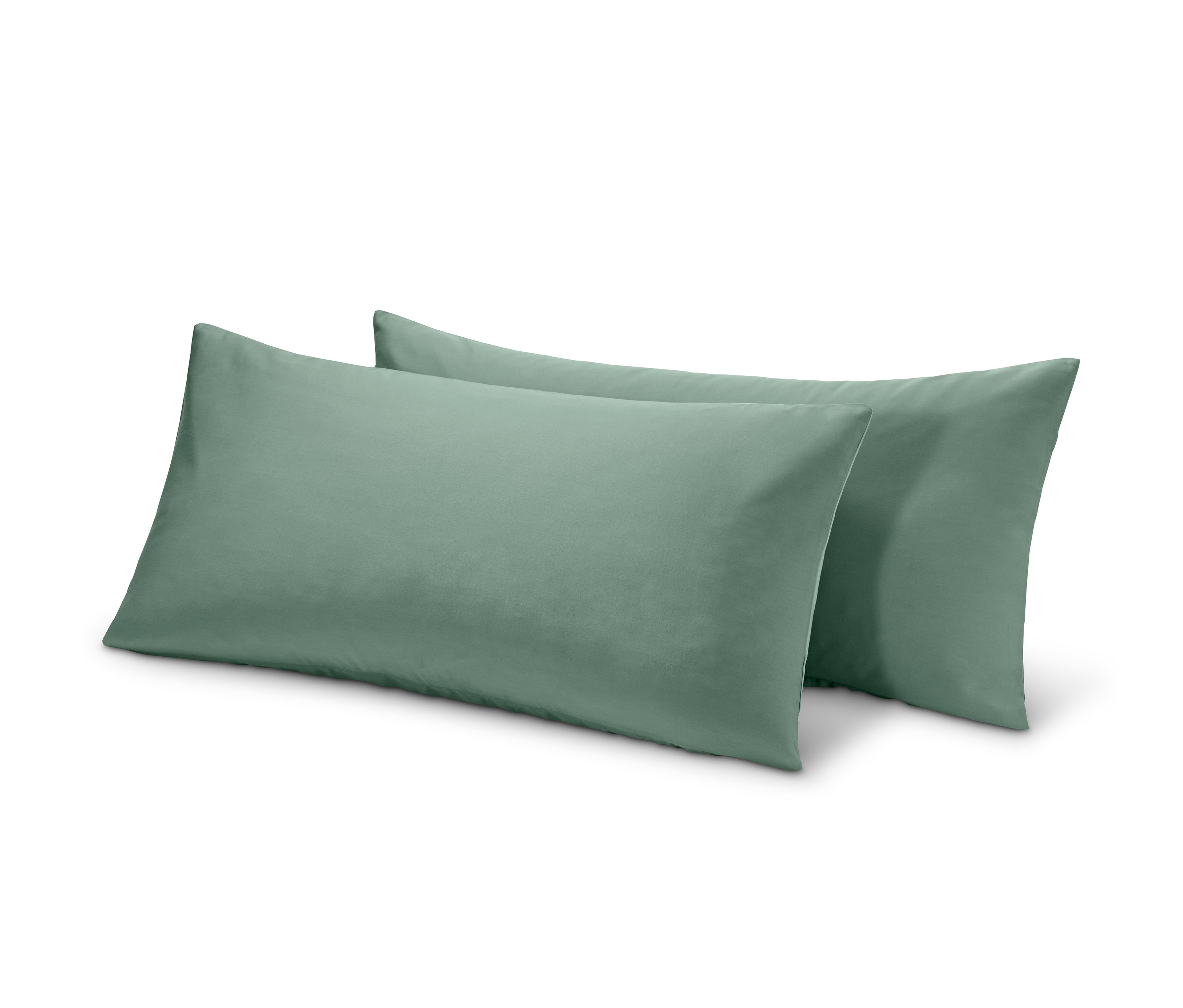 Zwei grüne TENCEL™-Baumwoll-Kopfkissenbezüge liegen nebeneinander.