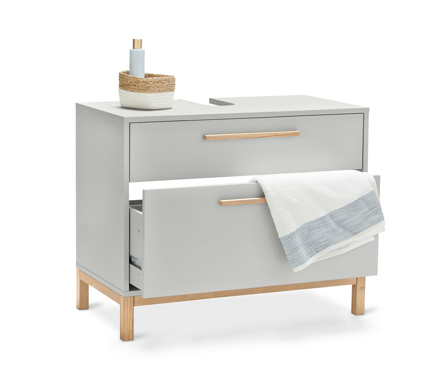 Ein hellgrauer Waschbecken-Unterschrank »Eklund« mit zwei Schubladen, wobei eine Schublade offen ist und ein Handtuch darauf liegt.