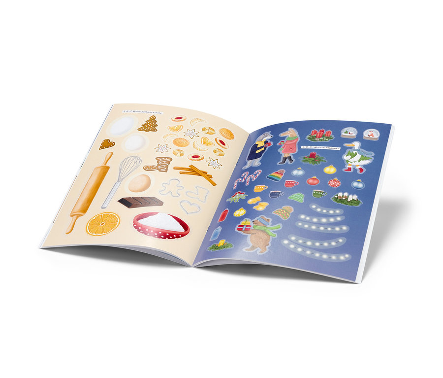 Offenes Stickerbuch: »Bezaubernde Weihnachtszeit« mit weihnachtlichen Aufklebern, darunter Gebäck, Dekorationen und Figuren.