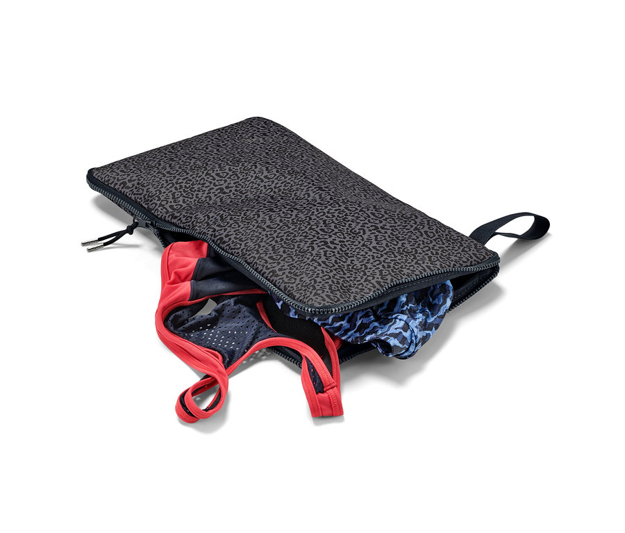 Eine geöffnete 2-in-1-Umzieh-Unterlage-Nasssack mit Kleidung darin.