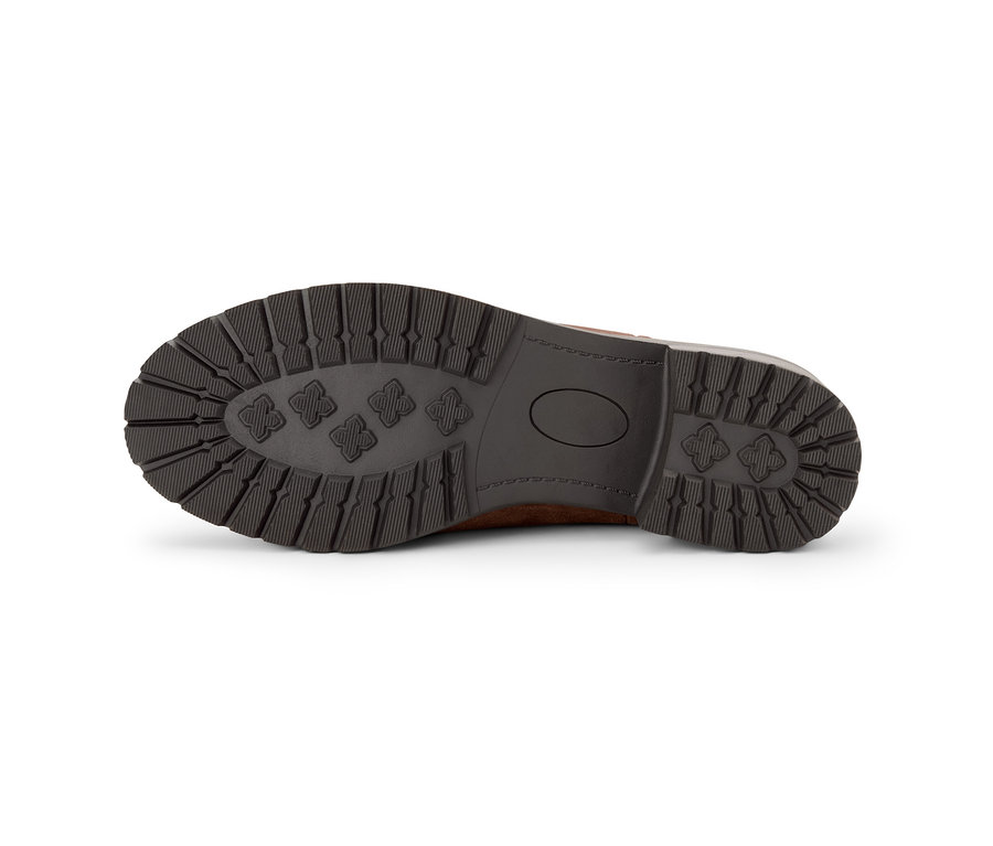 Die Unterseite eines Veloursleder-Boots mit brauner Sohle.
