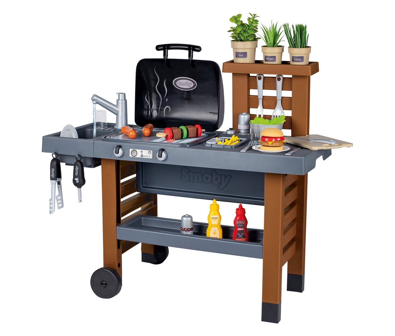 Smoby Outdoor-Gartenküche mit Grill, Spüle, Spiellebensmitteln und Kräutern auf einem Tisch mit Rädern.