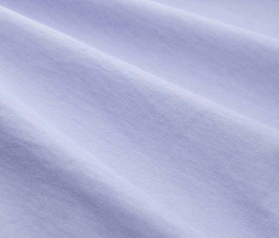 Nahaufnahme von drapiertem, hellblauem Stoff mit subtiler Textur.