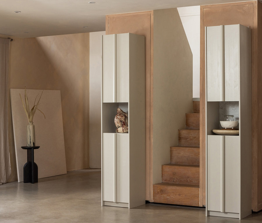 Zwei WOOOD »Basu« Schränke in Kiefer Dust flankieren eine Treppe. Im linken Schrank steht eine Skulptur.