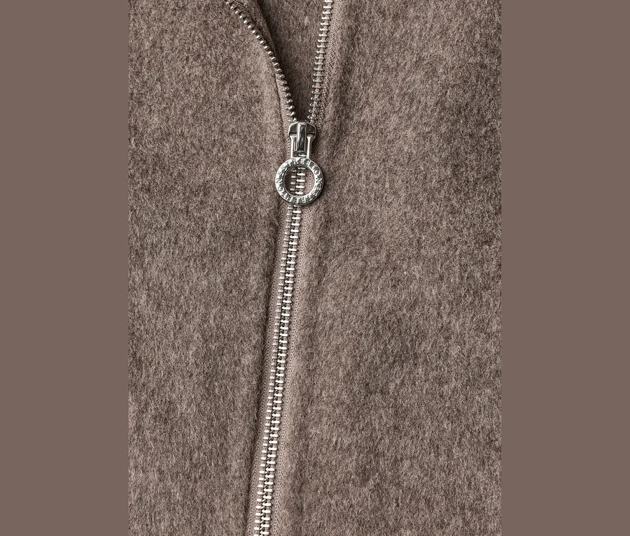 Nahaufnahme einer Street One Übergangsjacke in Braun mit einem silbernen Reißverschluss und einem runden Zipper mit "STREET ONE"-Gravur.