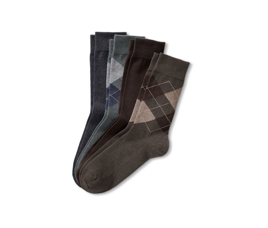 Vier Paar Socken in Grau- und Brauntönen mit verschiedenen Mustern.