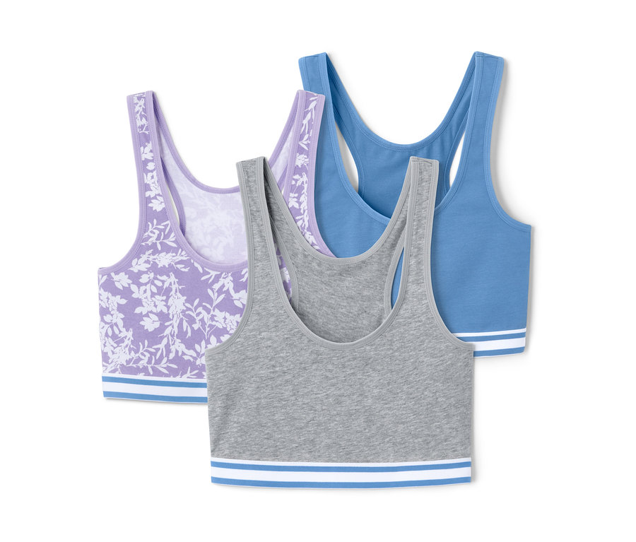 Drei Bustiers: ein lila Bustier mit Blumenmuster, ein graues und ein blaues.