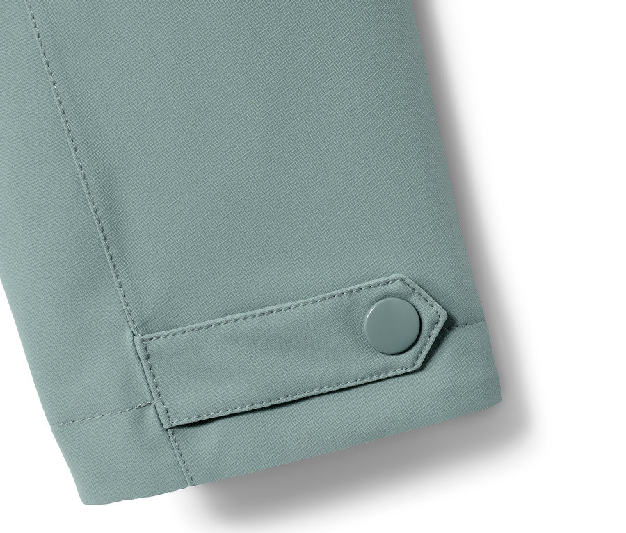 Detailansicht Ärmel eines Regen-Trenchcoats mit Knopf.