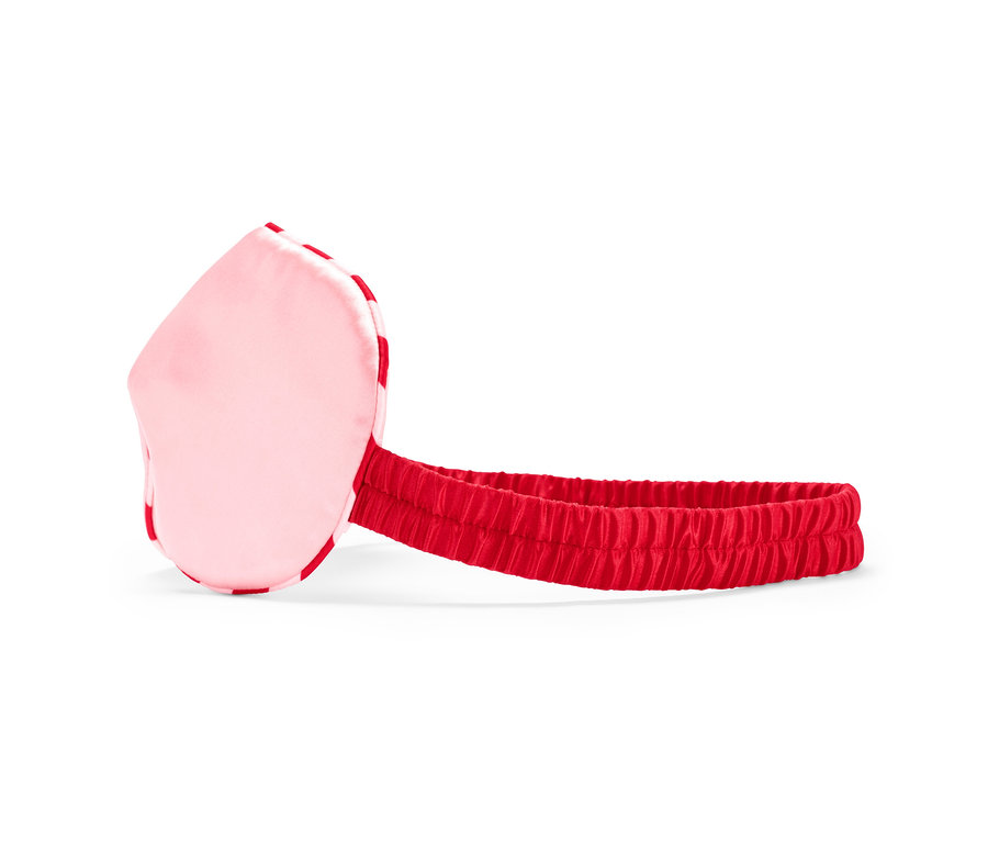 Eine rosa Schlafmaske mit einem roten Gummiband.