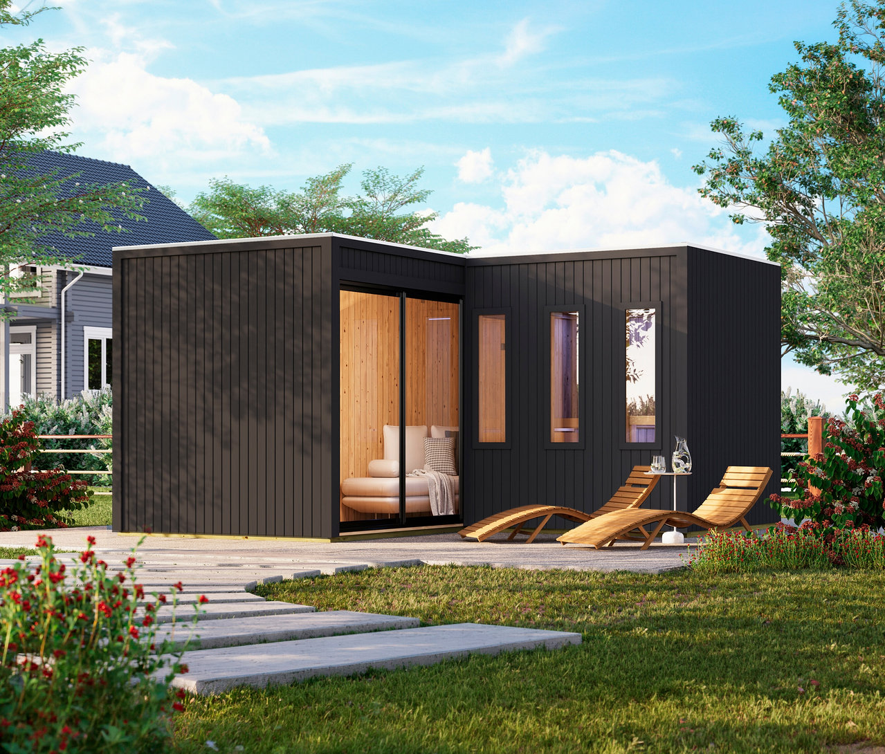 Modernes, schwarzes L-förmiges Karibu Saunahaus »Gwen«, Deluxe mit Holzinterieur und Glastüren in einem Garten, davor zwei Holzliegen auf einer Terrasse.