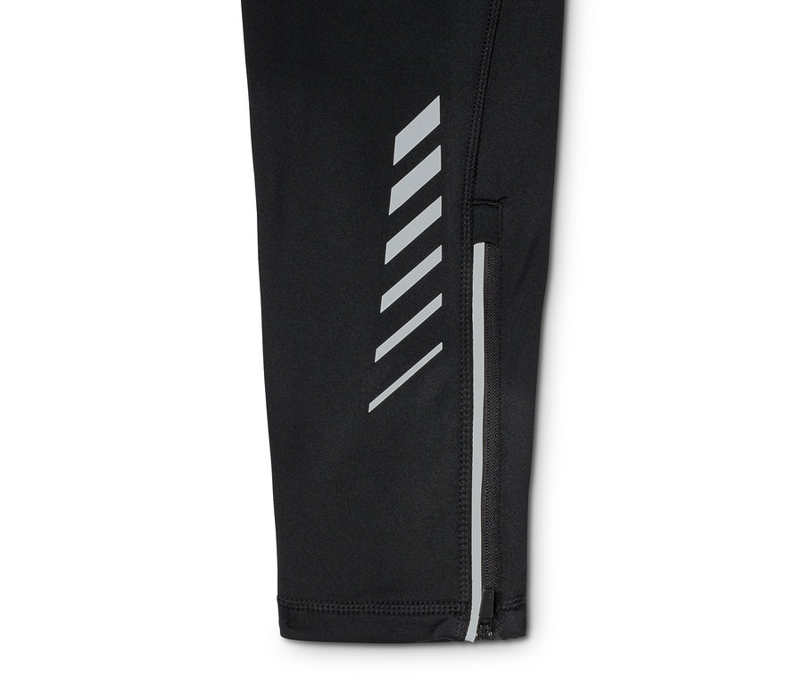 Detailansicht einer Thermo-Lauftight mit Reflektoren und Reißverschluss am Knöchel.