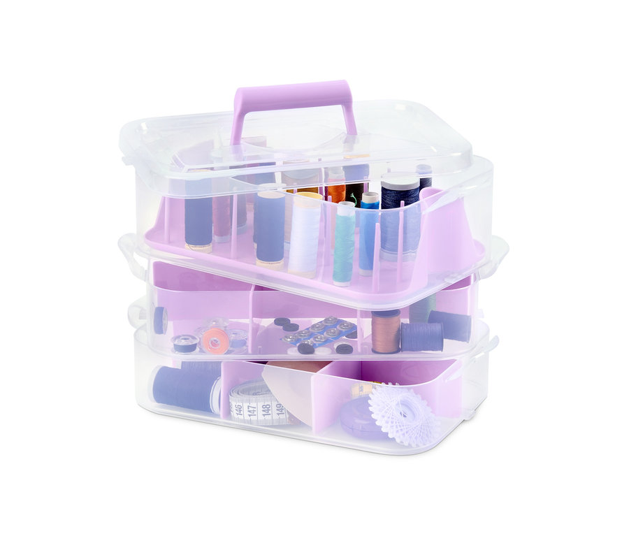 Ein Satz von drei Aufbewahrungsboxen mit transparentem Deckel und lila Fächern, gefüllt mit Nähzeug.