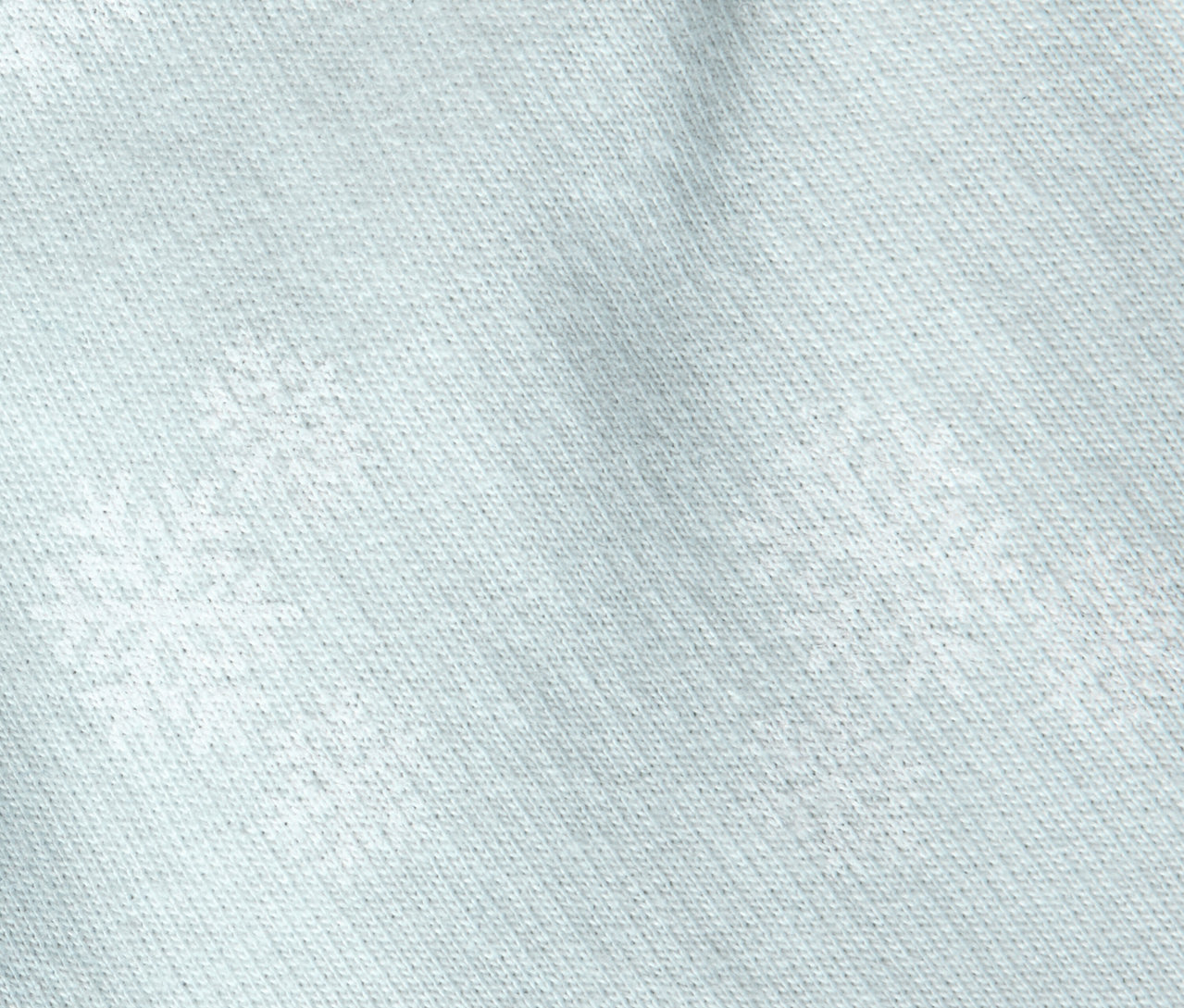 Detailaufnahme eines hellblauen Stoffes mit Schneeflockenmuster.