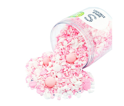 Rosa und weiße Super Streusel »KnuddelFee« Zuckerstreuselmix fallen aus einem transparenten Behälter.