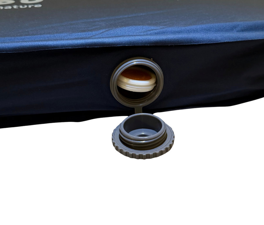 Nahaufnahme einer blauen Isomatte mit geöffnetem grauen Ventil.