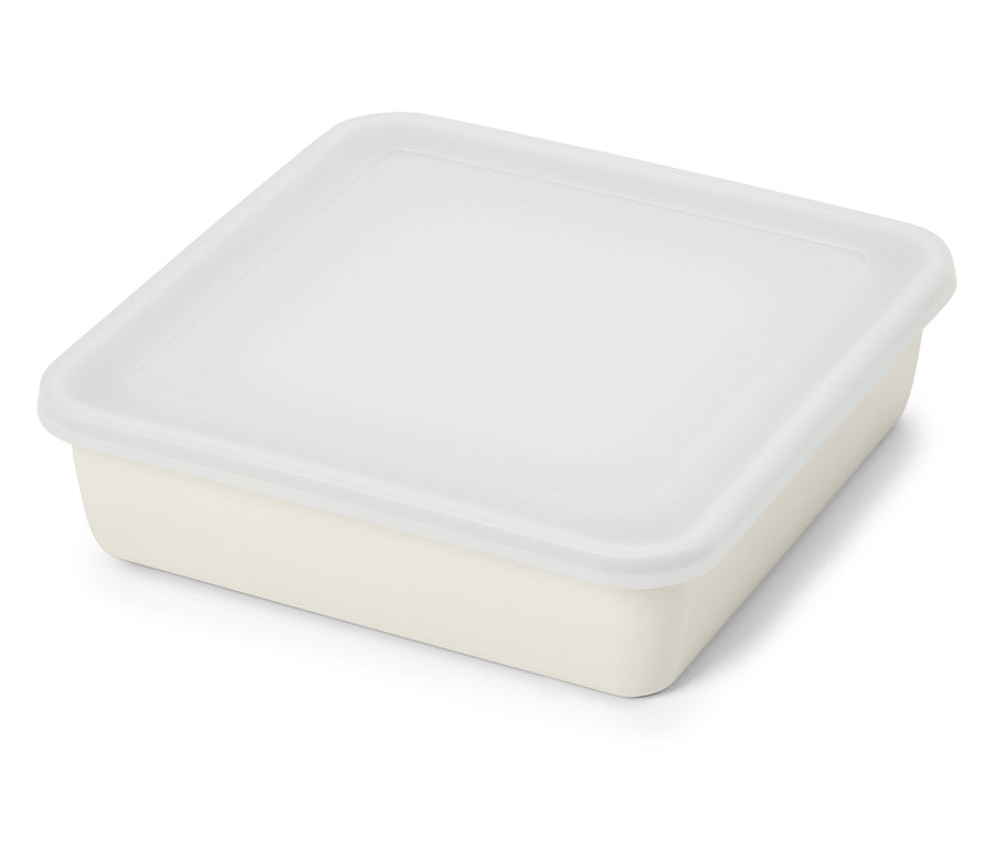 Beige, rechteckige Frischhaltedose mit transparentem Deckel liegt auf einer weißen Oberfläche.