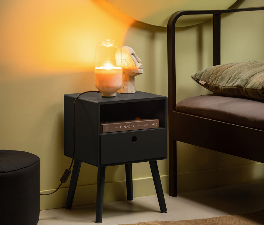 Lampe und Skulptur auf schwarzem Woood »Ozzy« Nachttisch neben Bett. Buch im Regal.