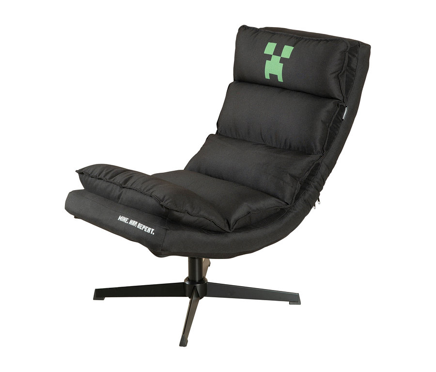 Schwarzer Gaming-Sessel mit zurückgelehnter Rückenlehne, grünem Minecraft Creeper Logo auf der Kopfstütze und „MINE. WIN. REPEAT.“ Schriftzug auf der Sitzfläche, auf schwarzem Drehfuß.