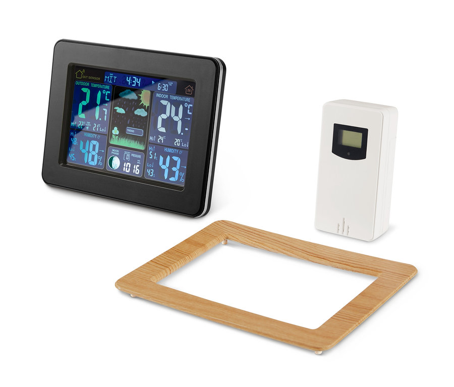 Eine schwarze Funk-Wetterstation mit LC-Farbdisplay, ein weißer Sensor und ein Holzrahmen.