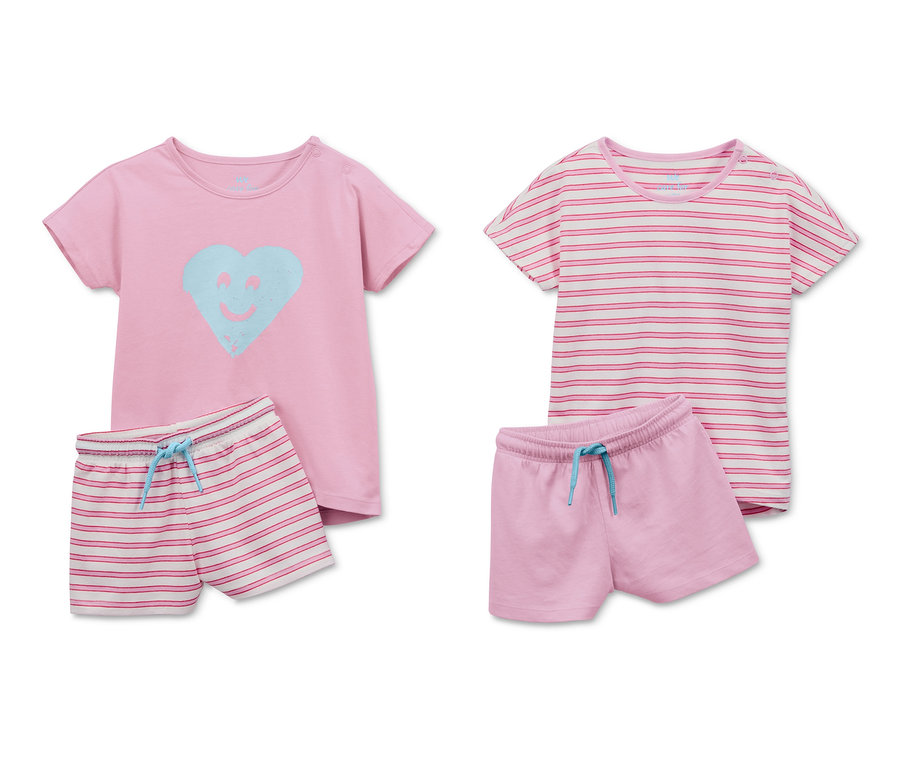 Zwei Shorty-Pyjamas aus Bio-Baumwolle: Einmal rosa T-Shirt mit blauem Herz und gestreifte Shortys, einmal gestreiftes T-Shirt und rosa Shortys.