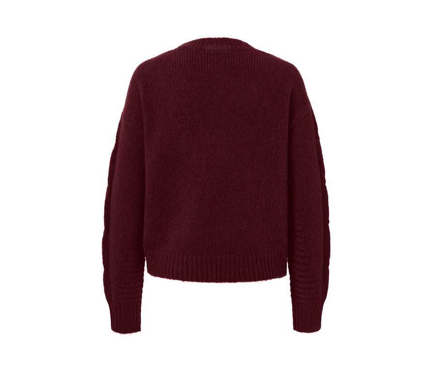 Detailansicht einer Strickjacke mit Zopfmuster.