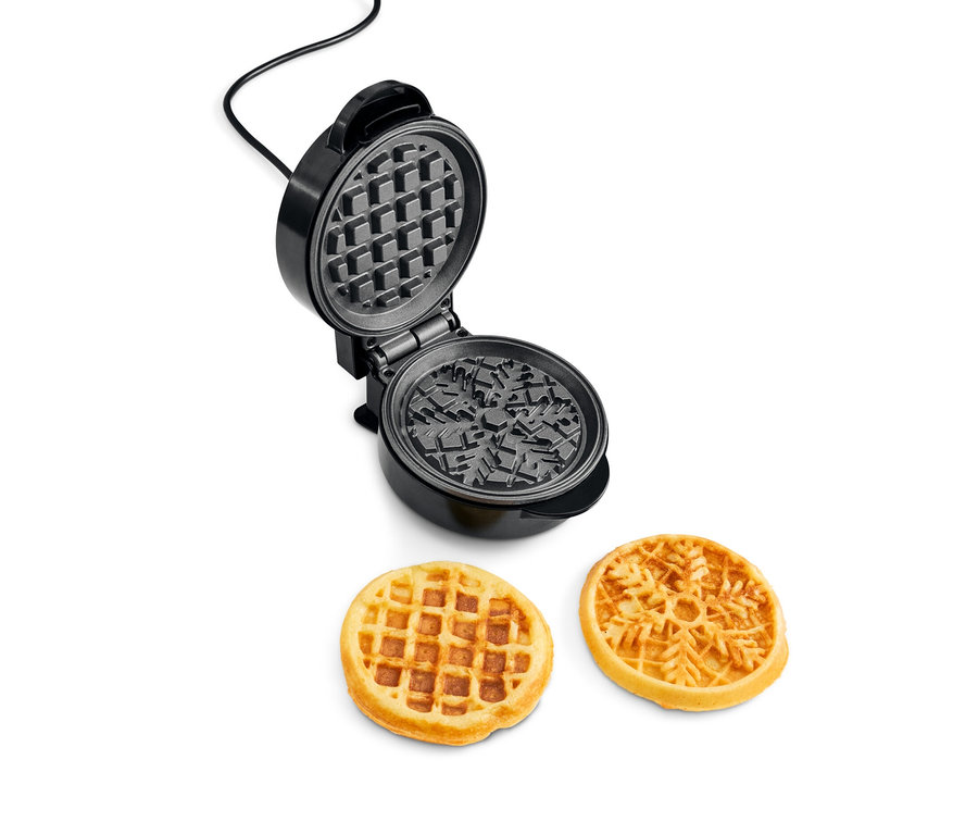Offenes Mini-Waffeleisen und zwei gebackene Waffeln.