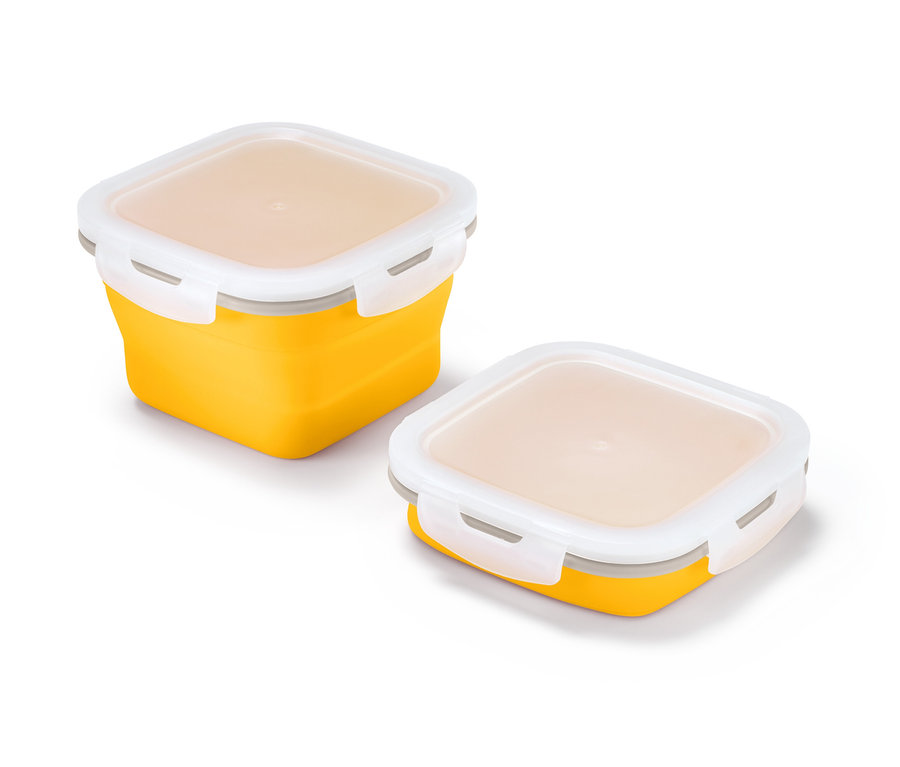 Zwei faltbare Frischhaltedosen in Gelb mit weißen Deckeln.