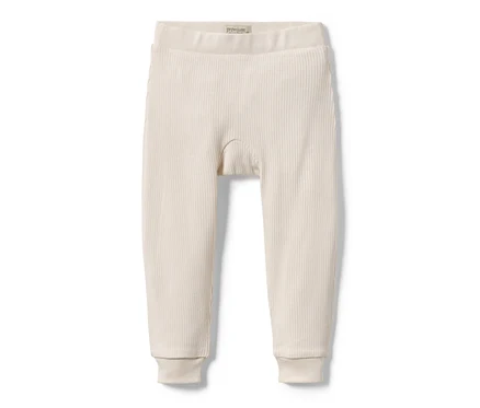 Eine hellbeige Baby-Strickhose liegt auf einem weißen Hintergrund.