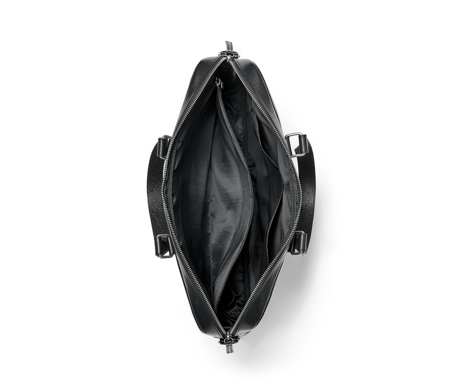 Detailansicht von oben auf eine offene schwarze Leder-Aktentasche.